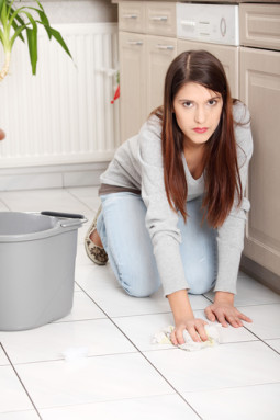 Young woman cleaning flor