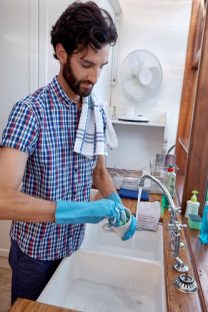 man washing dishes